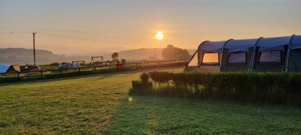 Hazy Sunrise behind a tent