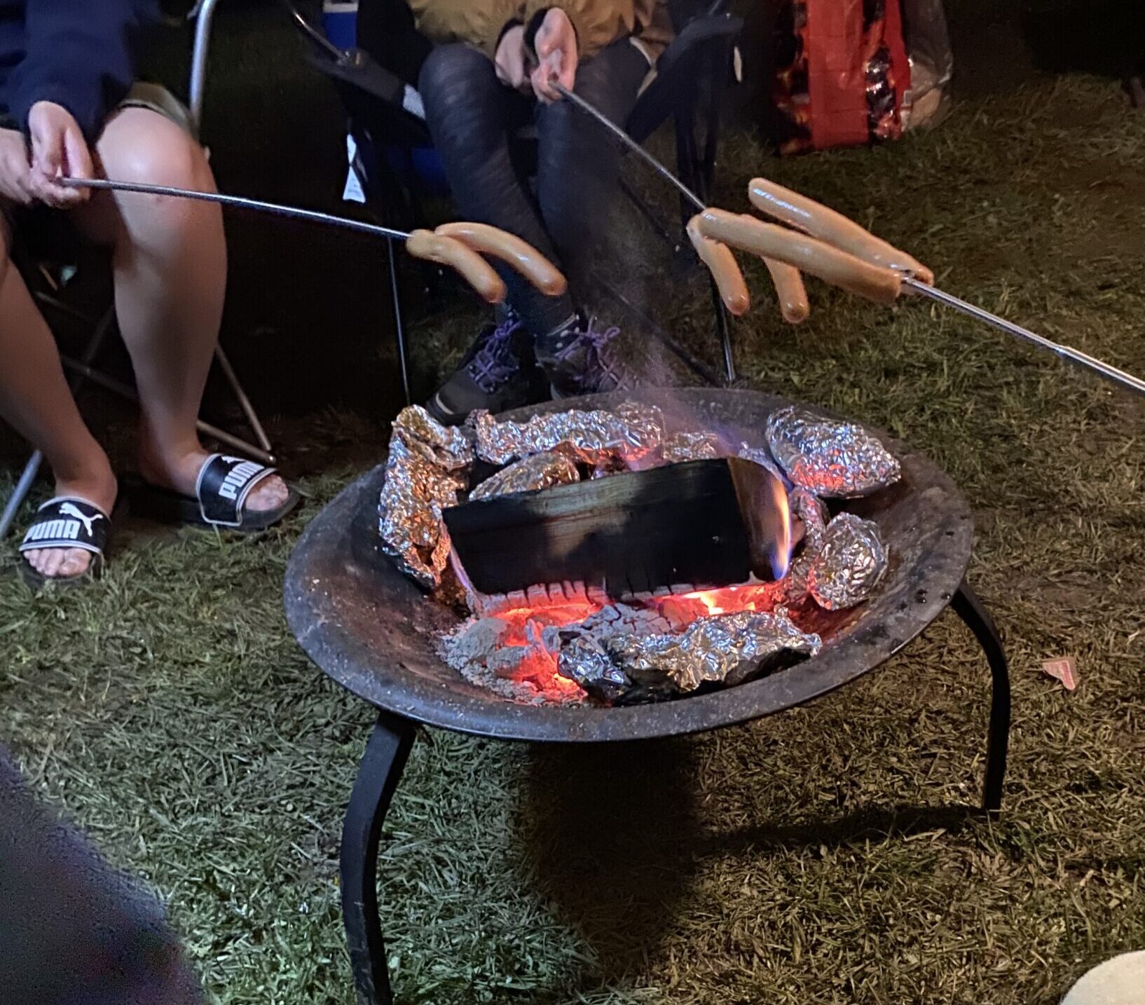 Cooking sausages over an open fire