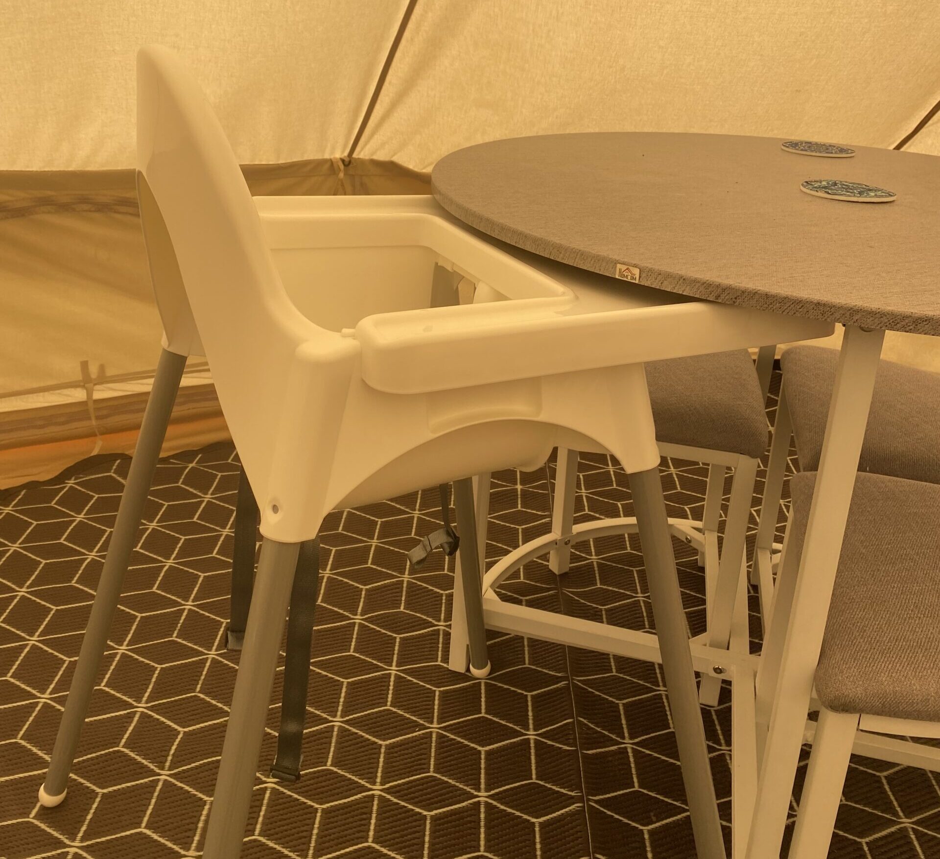 High chair with tray, that fits under a table in our glamping tents
