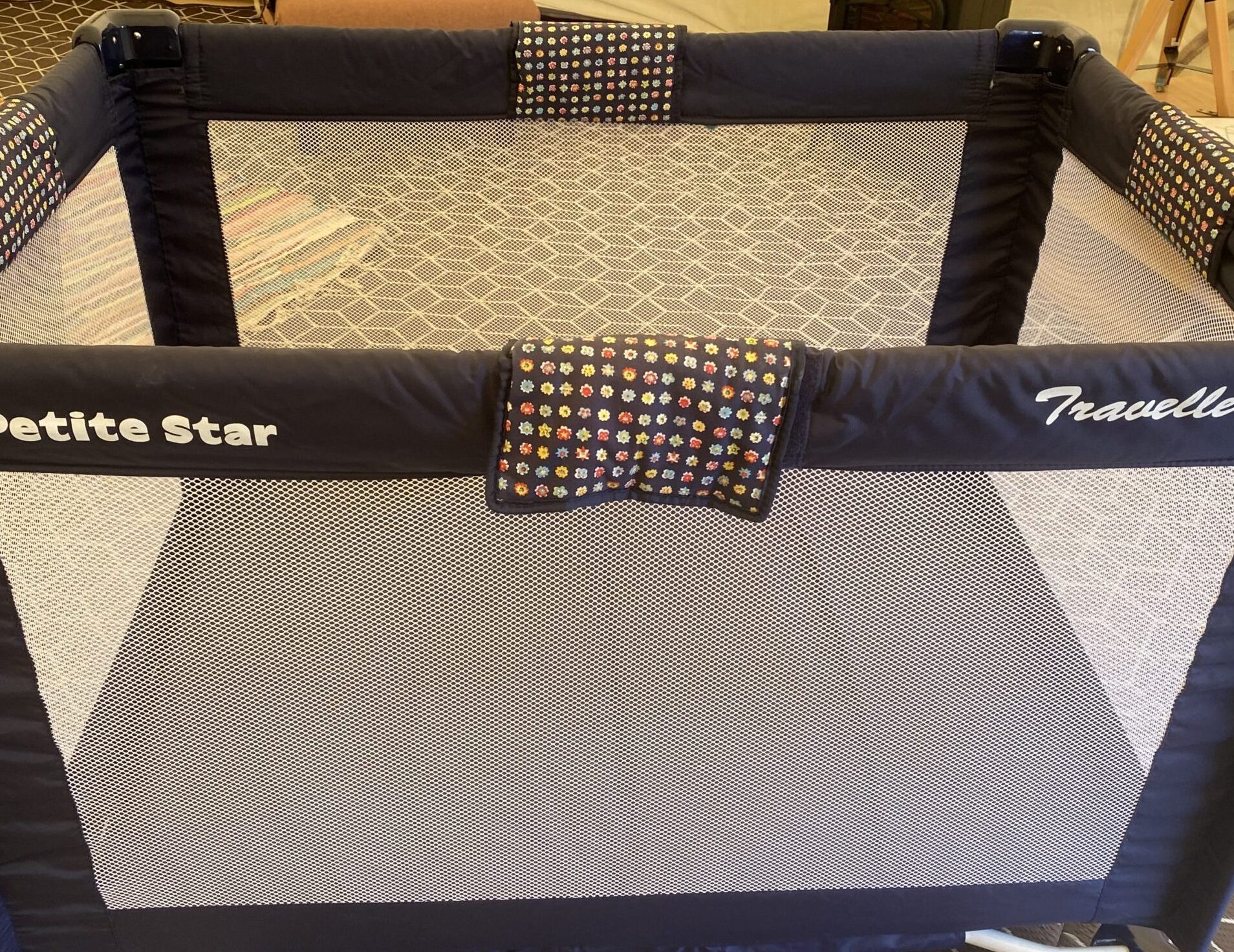 A blue children's travel cot