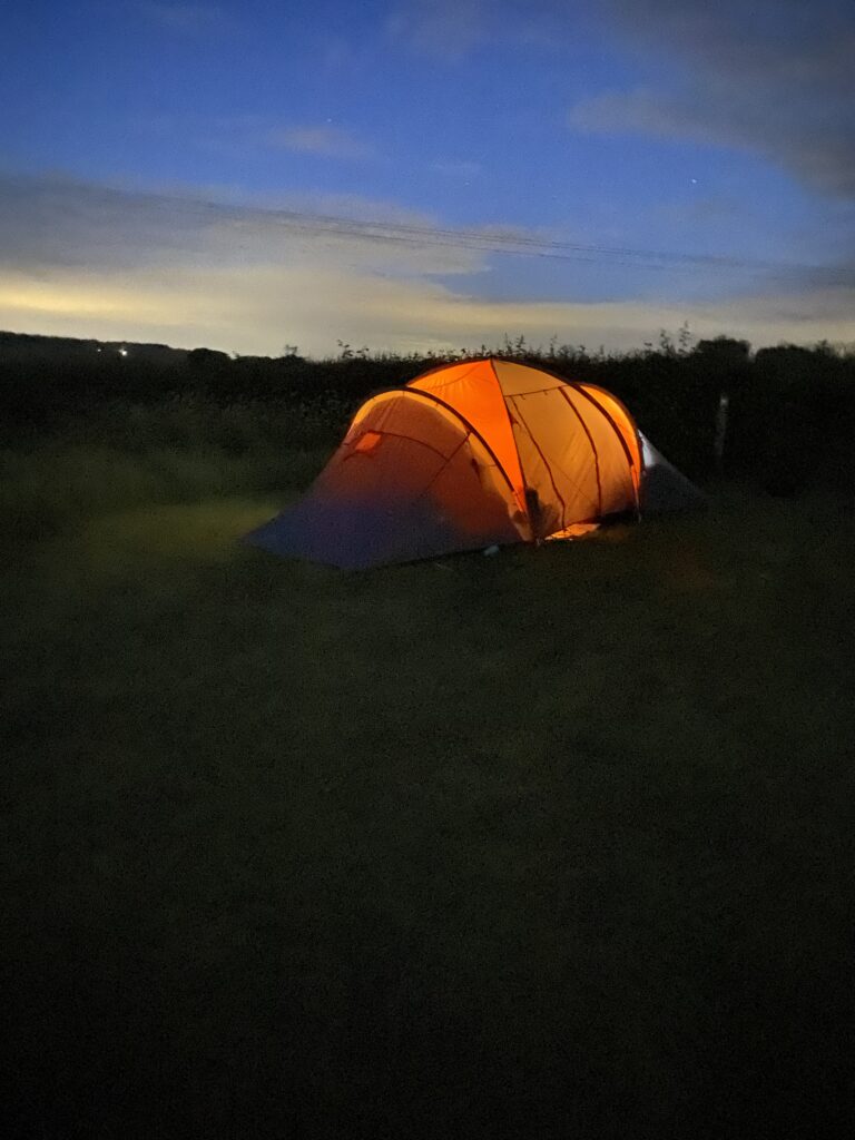 Illuminated tent under a night sky
