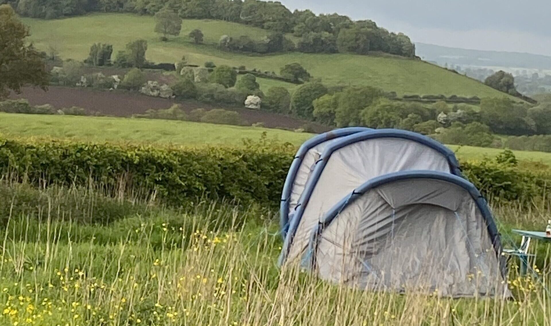 Tent in long grass overlooking the Staffordshire Moorlands